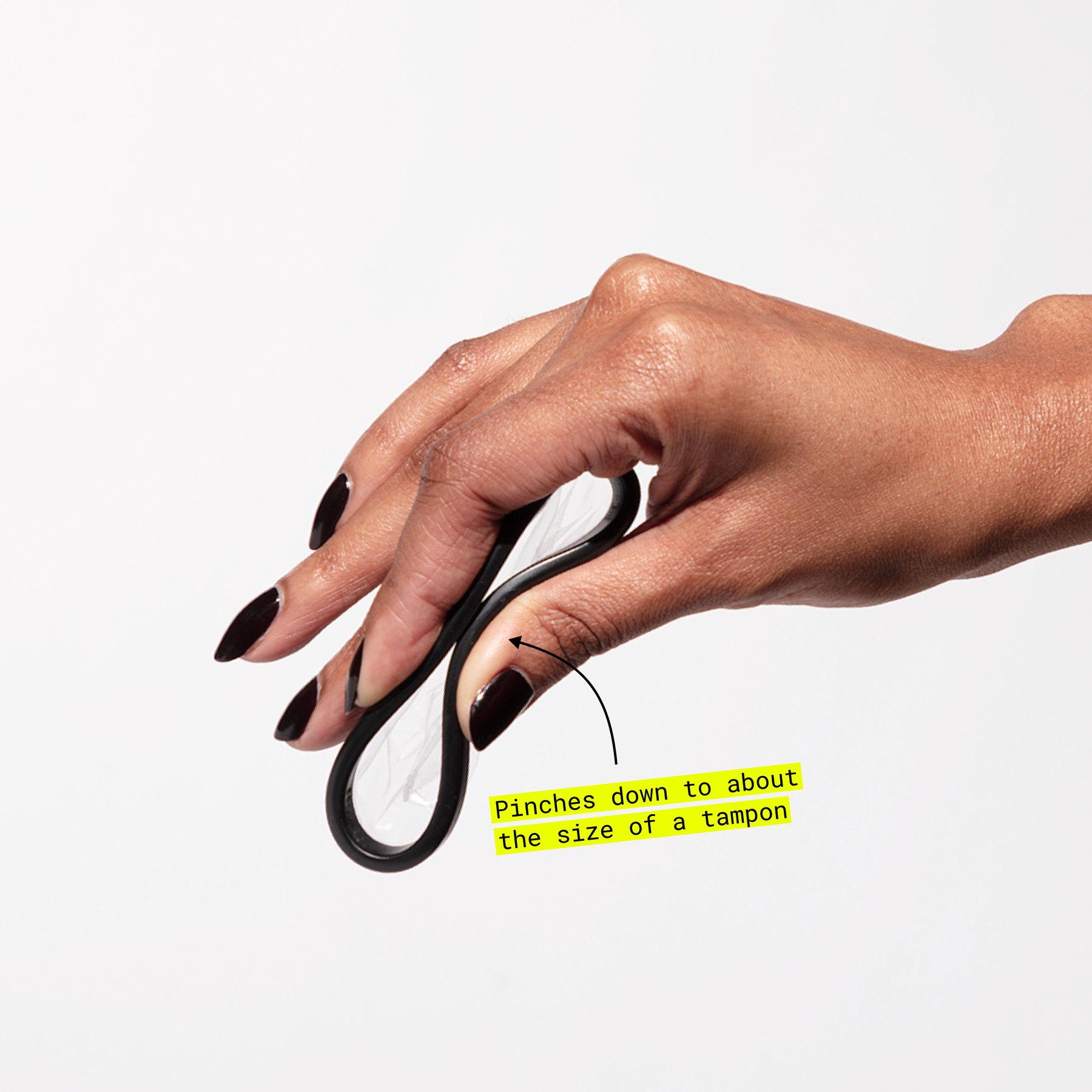 Hand pinching a folded menstrual disc with text showing size comparison to a tampon